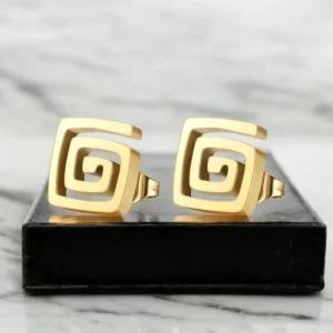 Modelo luciendo pendientes dorados cuadrados con espiral de diseño minimalista